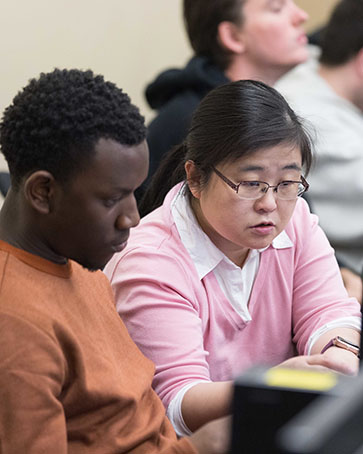 PNW students collaborate at a computer