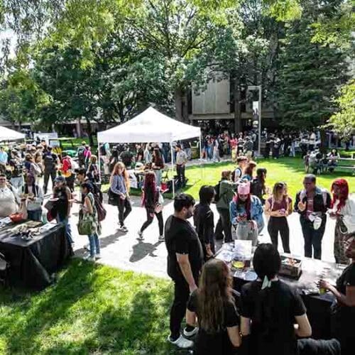 Students, faculty and staff gather outdoors on the PNW Hammond Campus