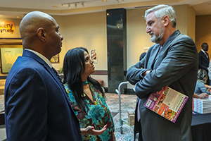 Exoneree Timmy Donald, Nicky Jackson and Indiana Governor Eric Holcomb chat before the start of the Center for Justice and Post-Exoneration Assistance dinner.