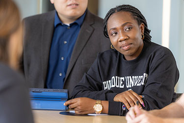 A PNW student listens in the classroom