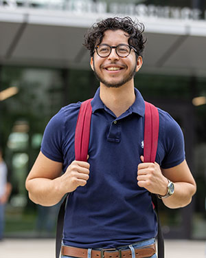 A student stands outdoors at PNW