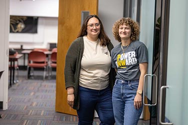 Two PNW advisors standing in the First-Year Advising office