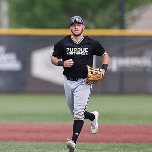 A PNW baseball player runs in from the field