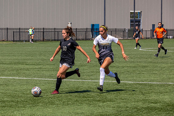 A PNW soccer player runs on the field