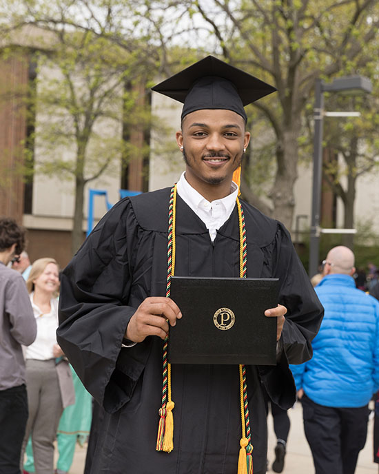 Graduate student received his degree on graduation day.