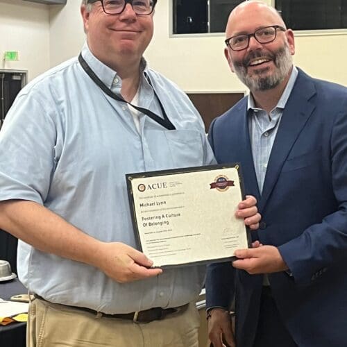 Michael Lynn and Aaron Bolton pose with an ACUE certificate