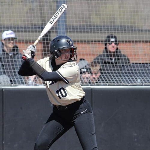PNW Softball member gets ready to hit the ball with bat.