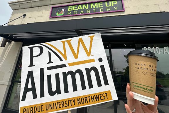 A PNW Alumni sign in front of Bean Me Up Roastery