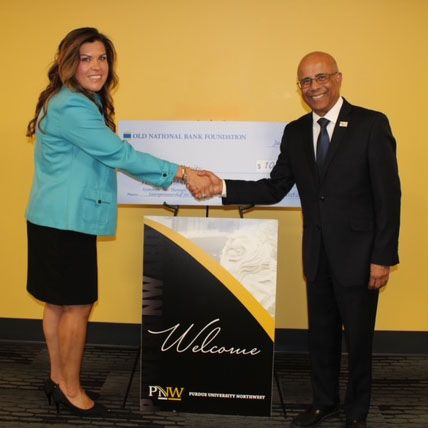 Monica Rubio and Niaz Latif shake hands.