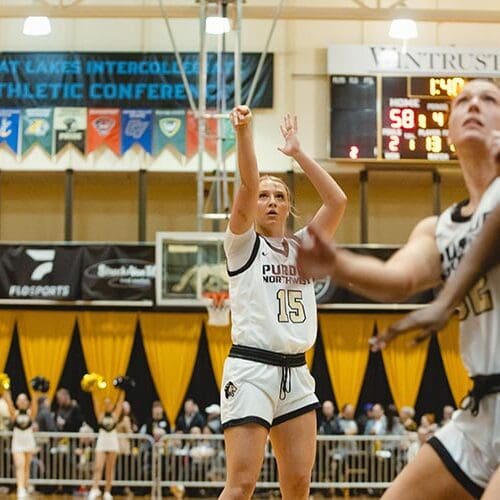 PNW Women's Basketball team. Player in white jersey shooting the basketball