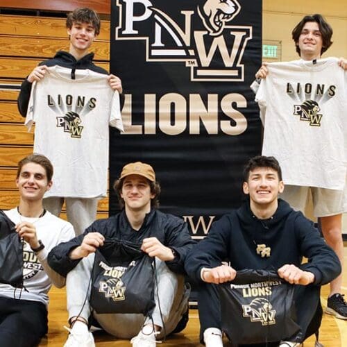 Purdue University Northwest student-athletes pose for a group photo with PNW Lions swag.