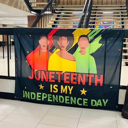 A flag that features three graphics of people and reads "Juneteenth is my independence day"