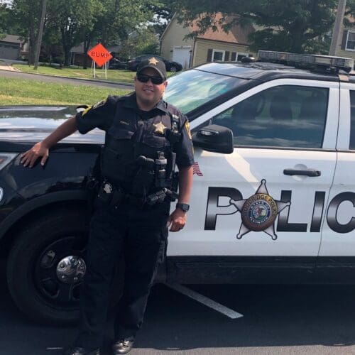 Police Officer by patrol car