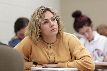 A woman listens in the classroom