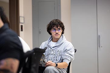 PNW student with a gray hoodie on looking at the professor while they are teaching 363x242