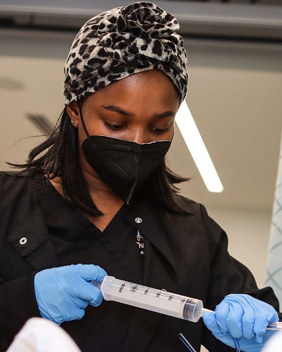 A student uses a syringe