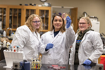 Students examine a petri dish