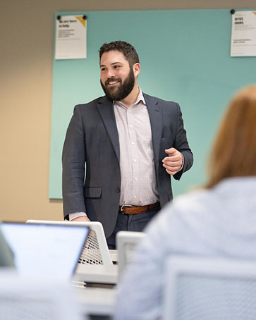 A professor stands in front of a class