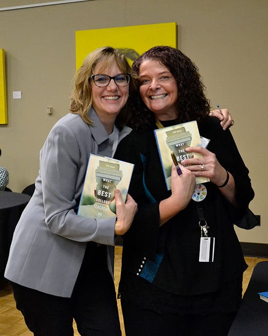 Faculty holding books