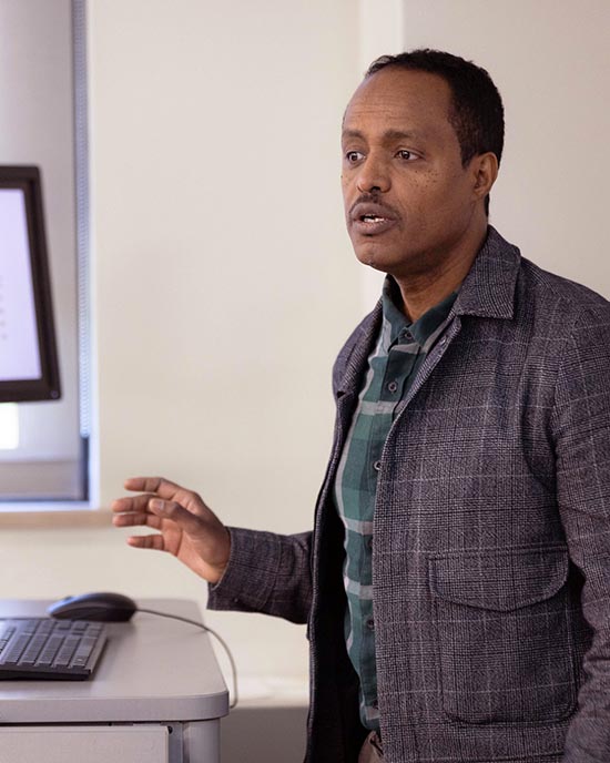 A Professor stands in front of a class