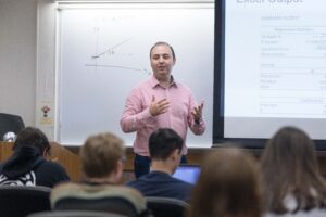 Faculty member teaching math concept