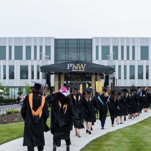 Students walking in commencement 2021.