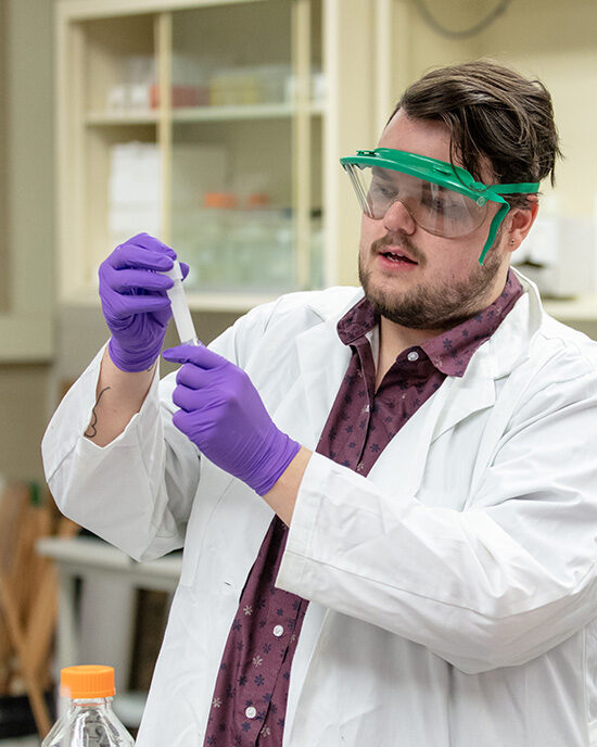 A PNW student conducts a chemistry experiment