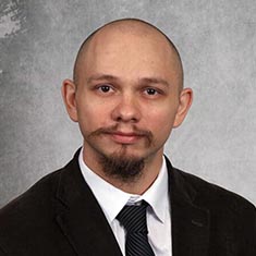 Professor Mitchell Howell in suit and tie