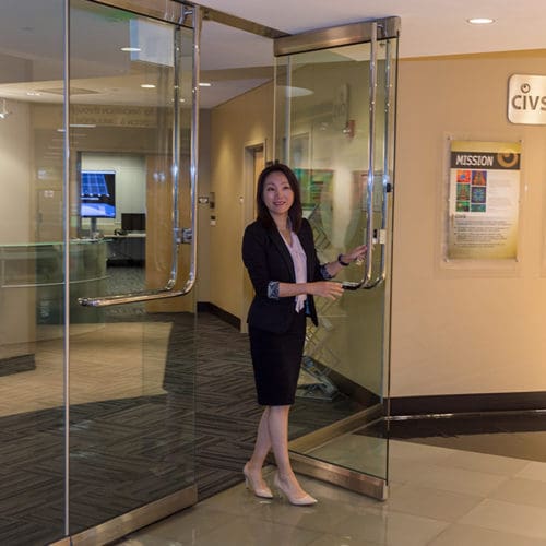 A person walks through a set of glass doors