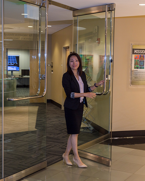 A person walks through a set of glass doors