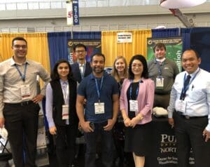 PNW attendees in front of their booth