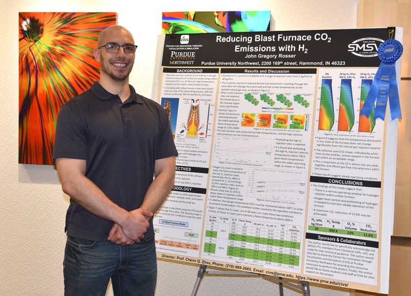 John Rosser stands next to his presentation board