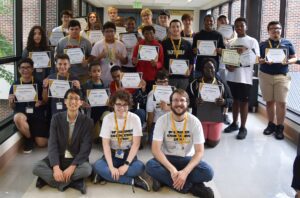 Camp participants pose together with their completion certificates.