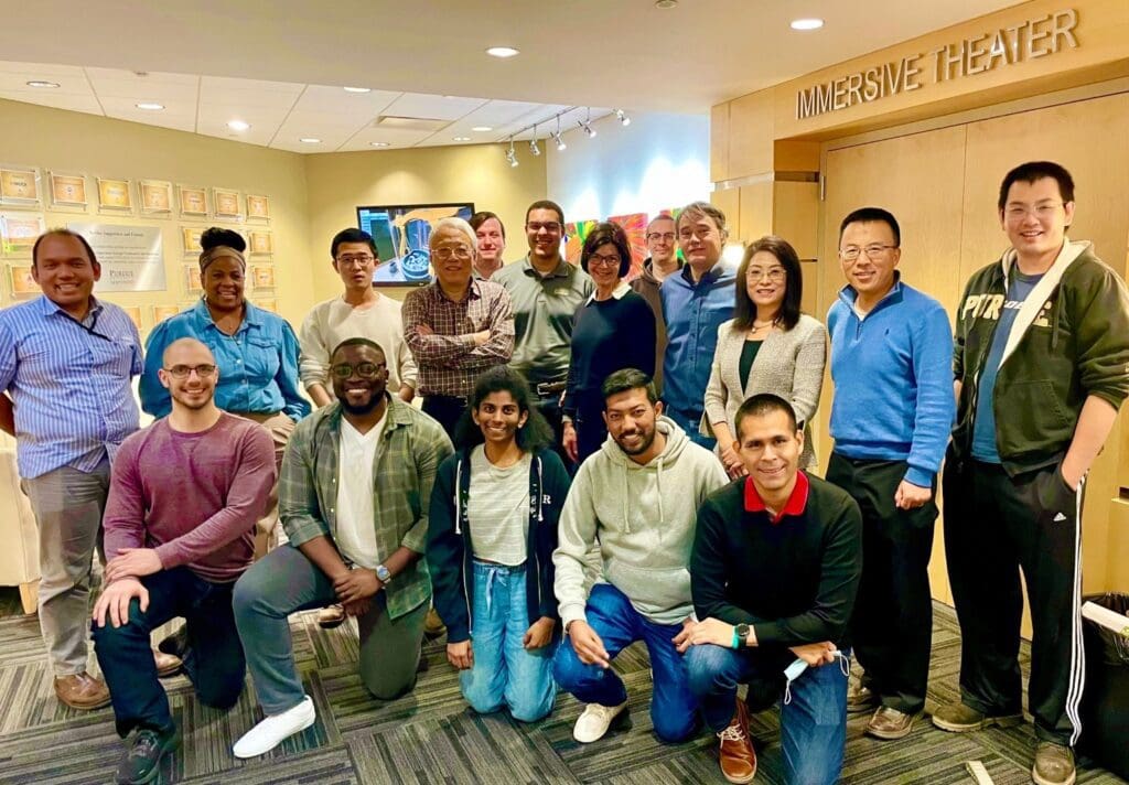 Researchers and partners pose in front of the CIVS Immersive Theater at Purdue University Northwest.