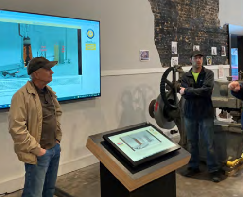 Historical society president opens the CIVS developed interactive simulation, at the Iron Industry Exhibit in the Alleghany Highlands Industrial Heritage and Technology Discovery Center.