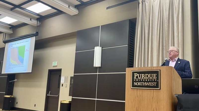 Man standing at podium in front of large conference room