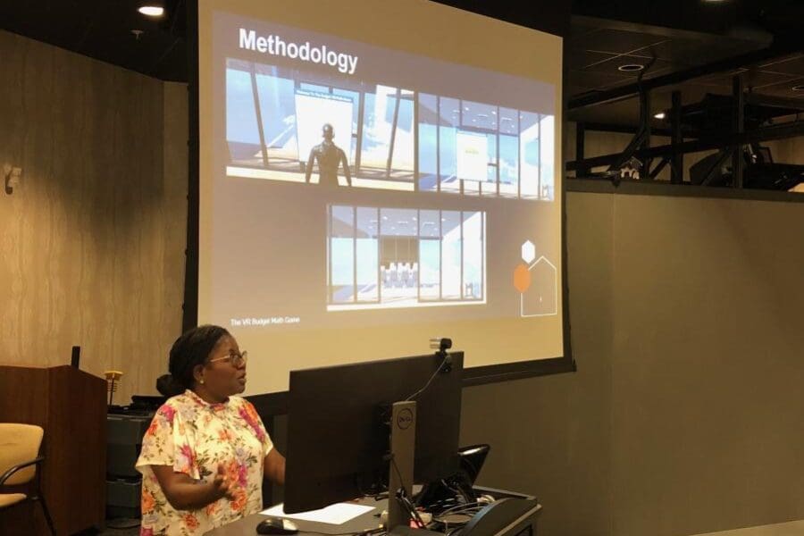 Woman standing in front of screen in auditorium