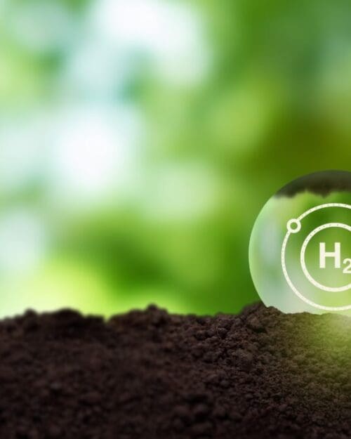Digital image of nature featuring loose dirt, a green background and a water droplet superimposed with the logo for Hydrogen (h2)