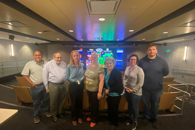 Group photo in front of screen