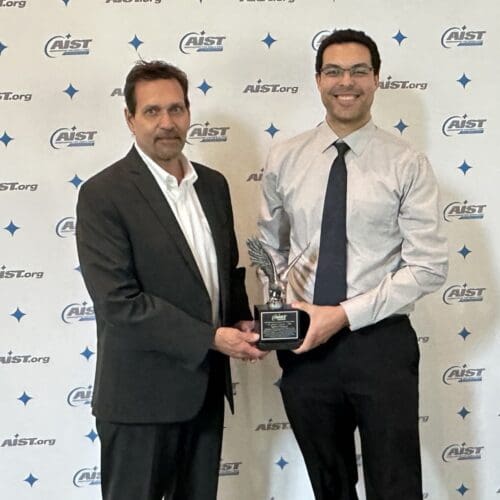 2 people holding an award