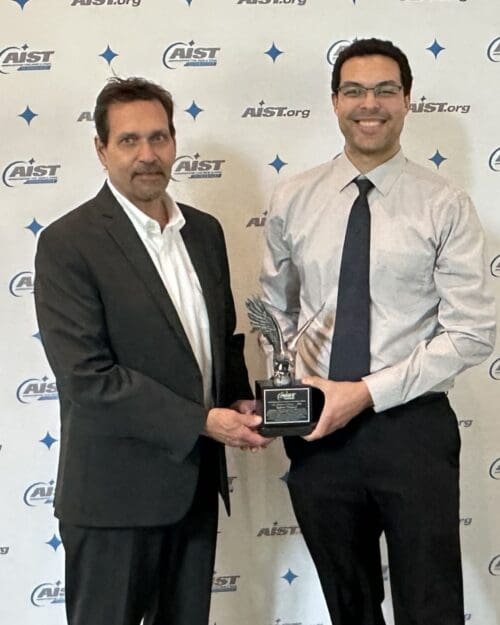 2 people holding an award