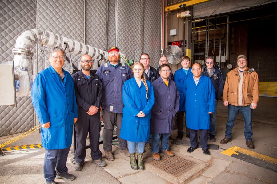 group of people at steel facility