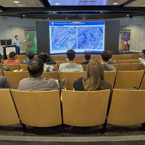 man giving lecture to students