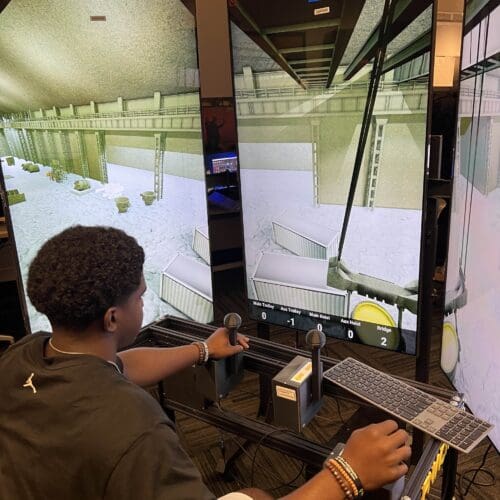 student operating crane simulator