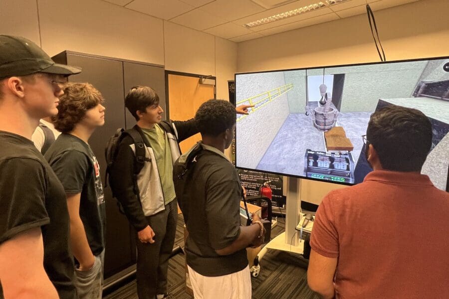 students demonstrating crane simulator