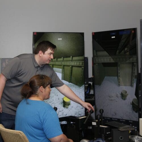Woman demonstrating crane simulator