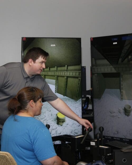 Woman demonstrating crane simulator