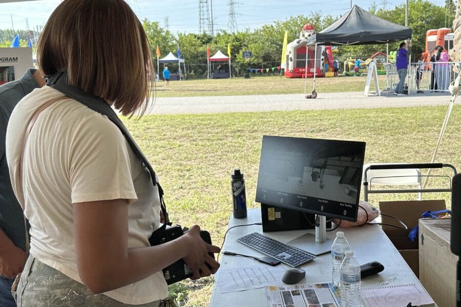 woman demonstrates crane simulator