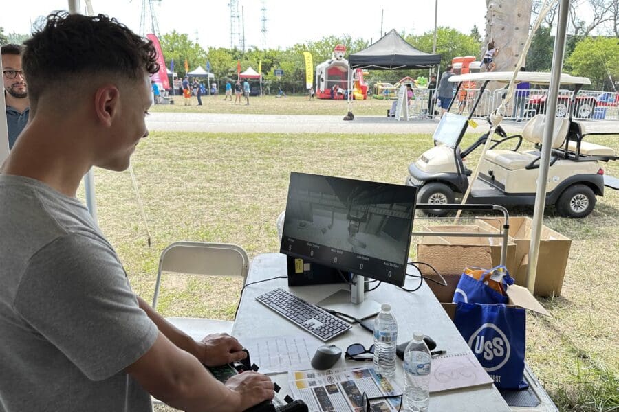 child demonstrates crane simulator