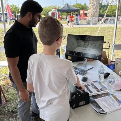 child demonstrates crane simulator
